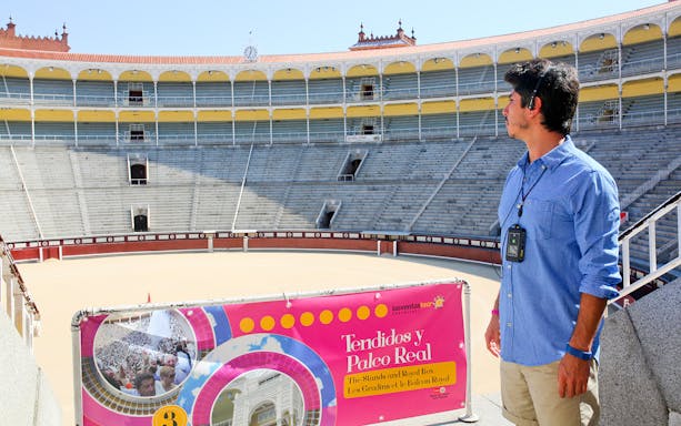 Man with audio guide at Las Ventas bullring in Madrid, viewing the arena.