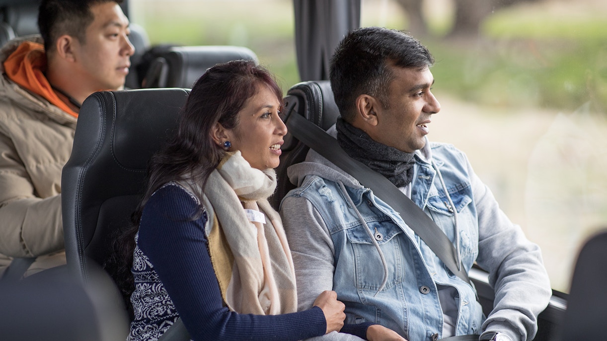 Tourists enjoying a scenic bus ride from Queenstown to Milford Sound.