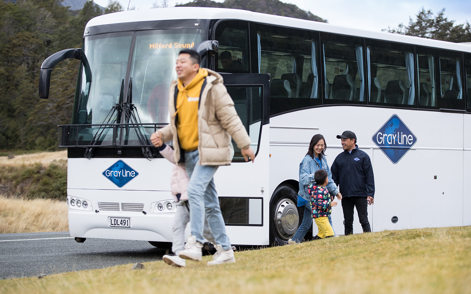 Bus tour group departing for Milford Sound from Queenstown.