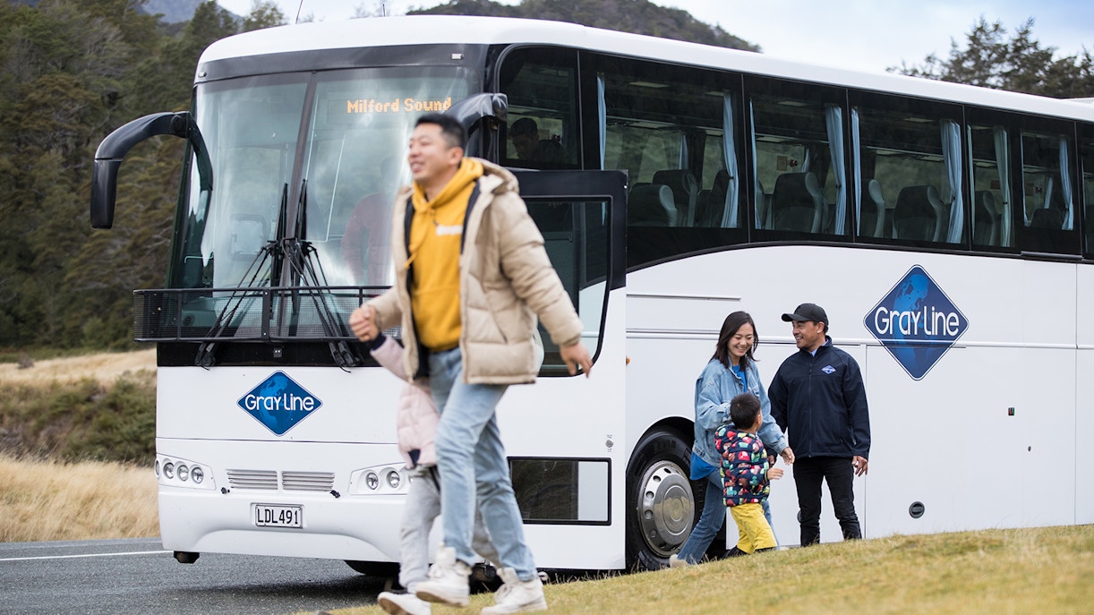 Bus tour group departing for Milford Sound from Queenstown.