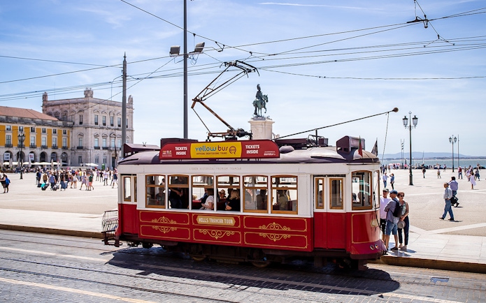 Lisbon tram in Praça do Comércio during a hop-on hop-off tour.
