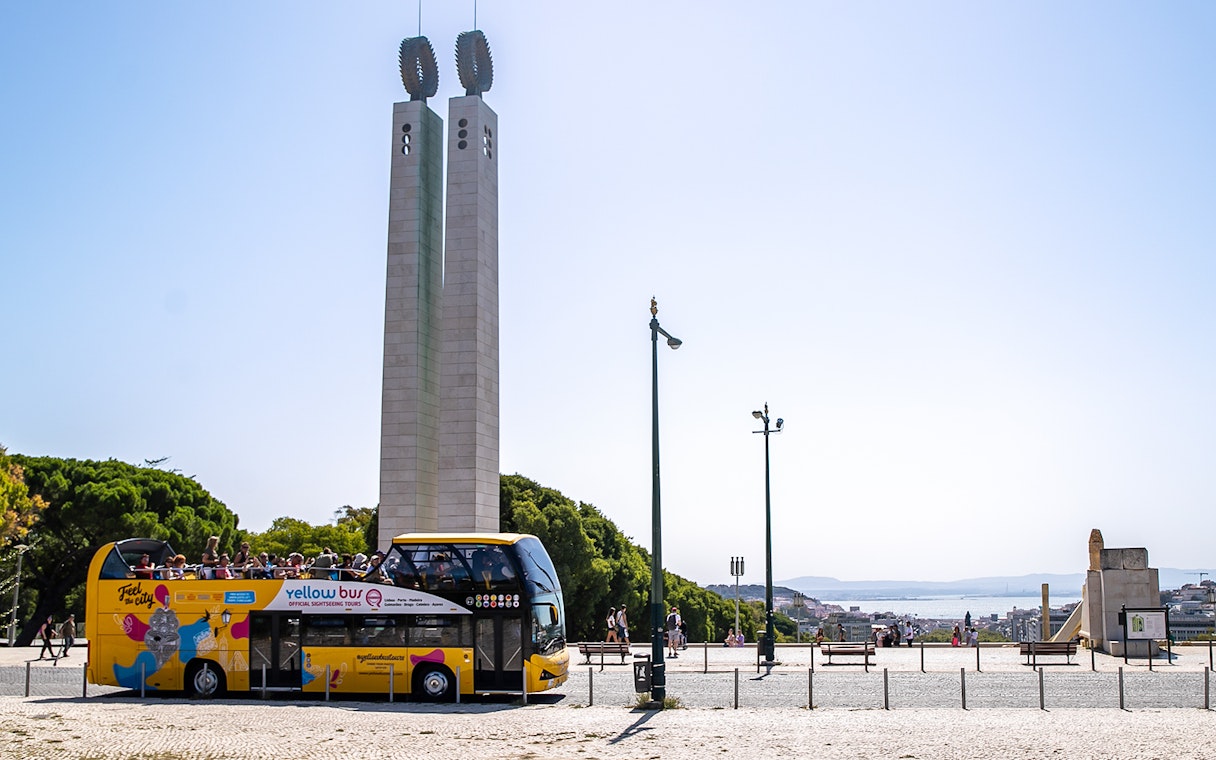 Lisbon hop-on hop-off bus near Eduardo VII Park monument.