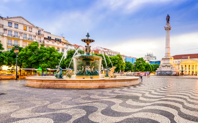 Rossio Square fountain and column in Lisbon, Portugal, part of the Lisbon Card and Hop-On Hop-Off Bus Tour.