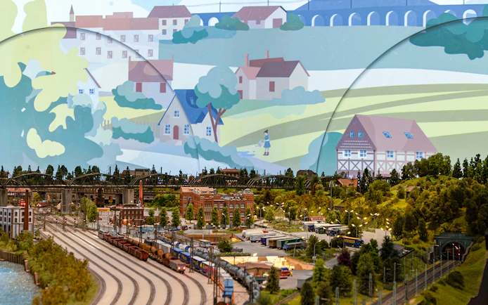 Miniature railway landscape with trains, buildings, and greenery at Hzero: The Miniature Railway Enterprise.