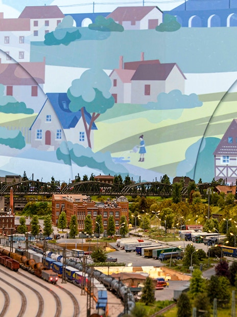 Miniature railway landscape with trains, buildings, and greenery at Hzero: The Miniature Railway Enterprise.