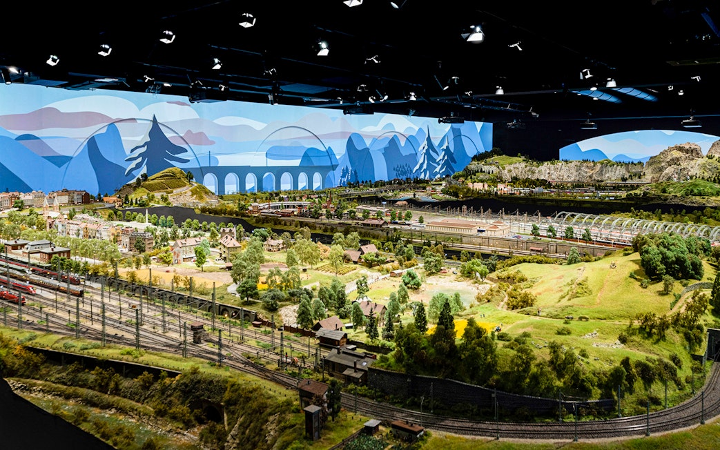 Miniature railway landscape at Hzero, featuring detailed model trains and scenic countryside.