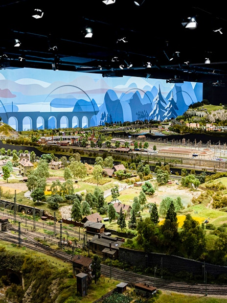 Miniature railway landscape at Hzero, featuring detailed model trains and scenic countryside.