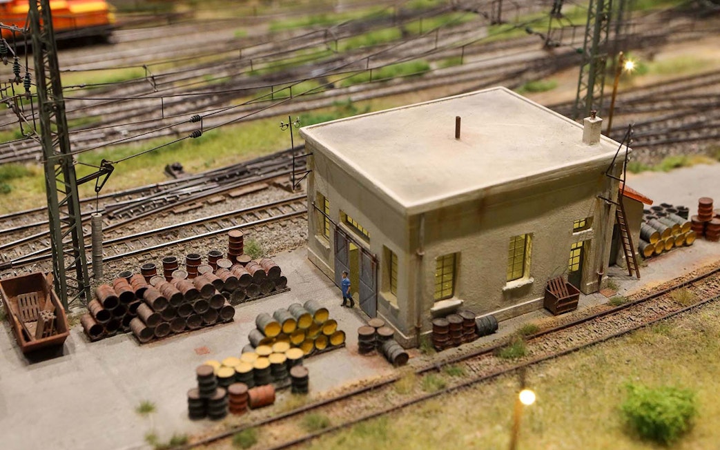 Miniature railway scene with building and barrels at Hzero Miniature Railway Museum.