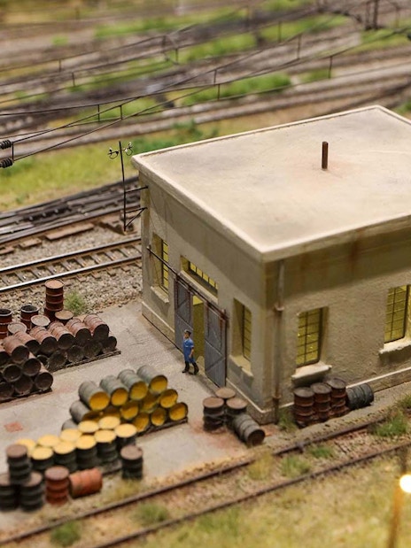 Miniature railway scene with building and barrels at Hzero Miniature Railway Museum.