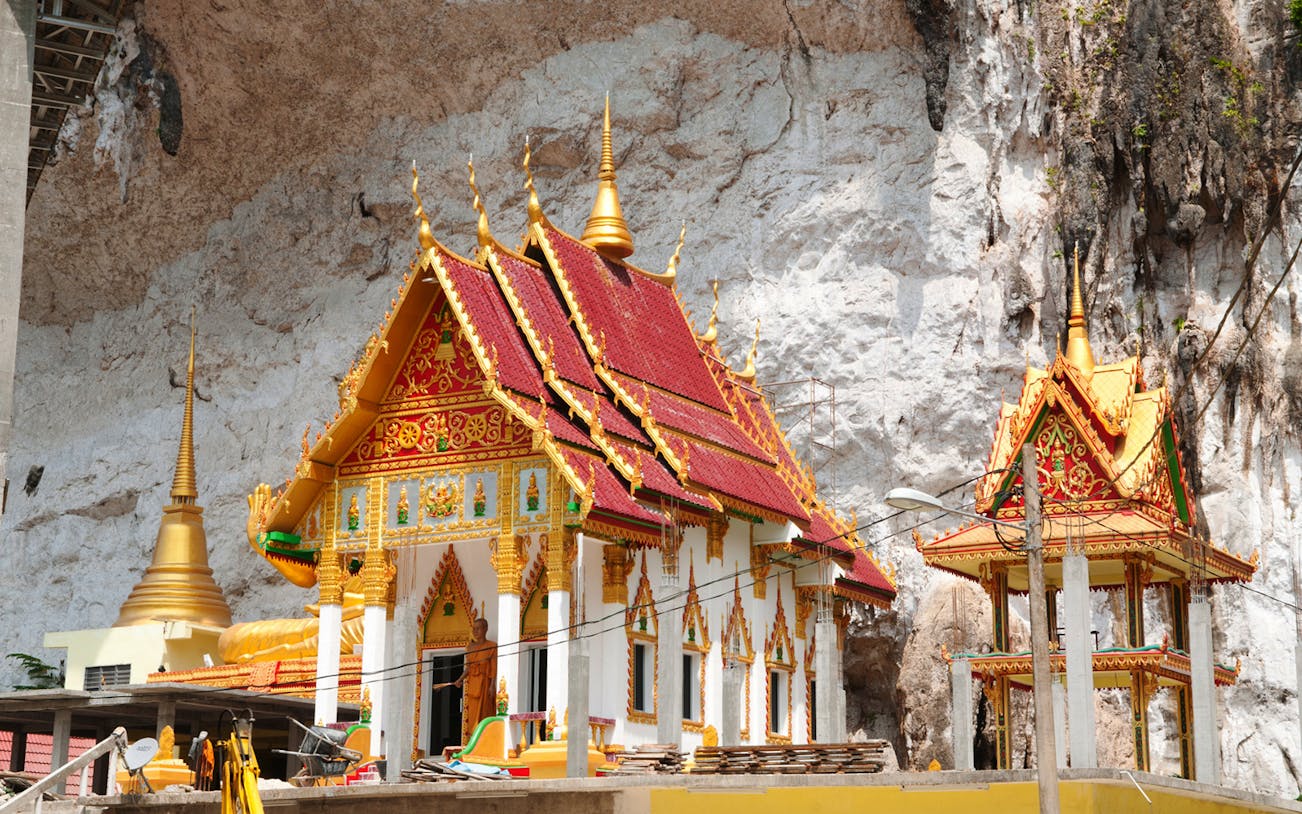 Buddhist temple with ornate red and gold roof in Langkawi, Malaysia.