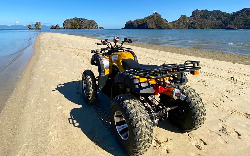 ATV on sandy beach with ocean view, Langkawi adventure tour.