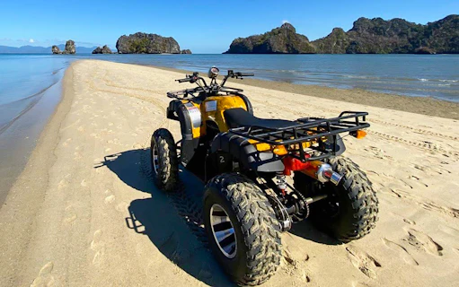 ATV on sandy beach with ocean view, Langkawi adventure tour.