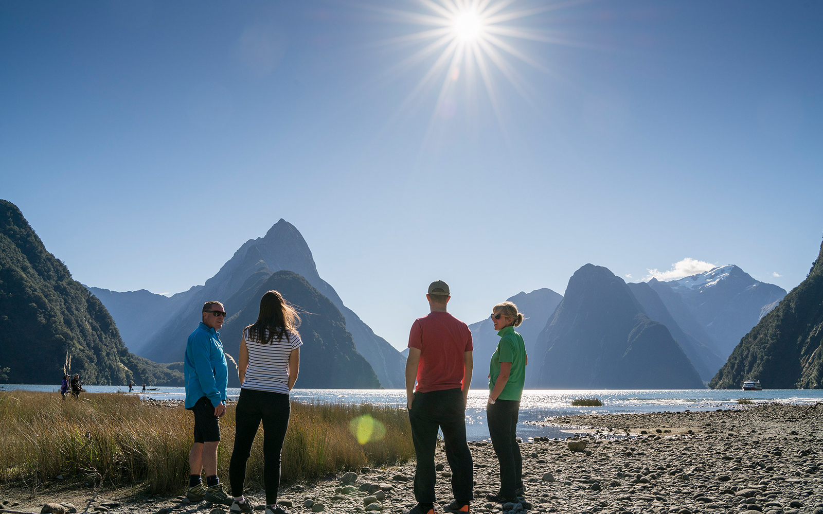 Visitors enjoying a guided wilderness walk at Milford Sound with mountain views.