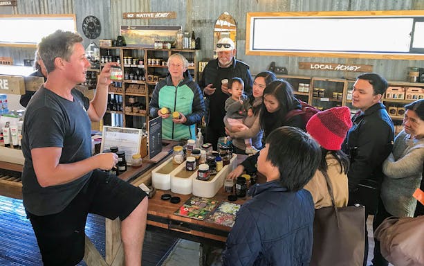 Group learning about local honey products during Arrowtown tour.
