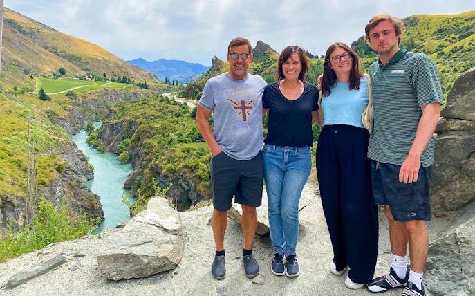 Group enjoying scenic view of Arrowtown canyon during half-day tour with Queenstown transfers.