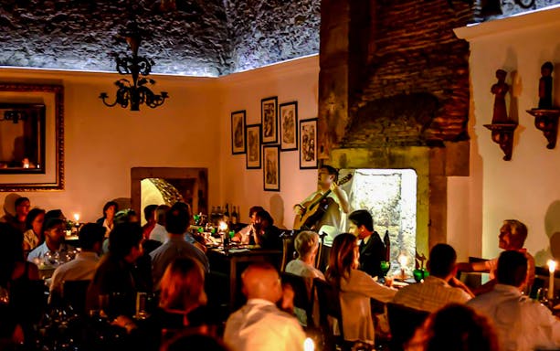 Fado performance during a night tour in Porto with dining guests.