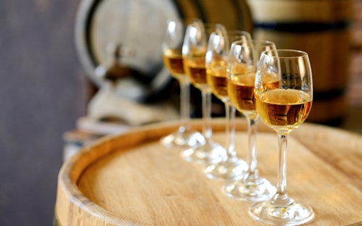 Wine glasses on a barrel during a wine tour in Èvora, Portugal.