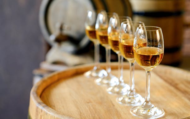 Wine glasses on a barrel during a wine tour in Èvora, Portugal.