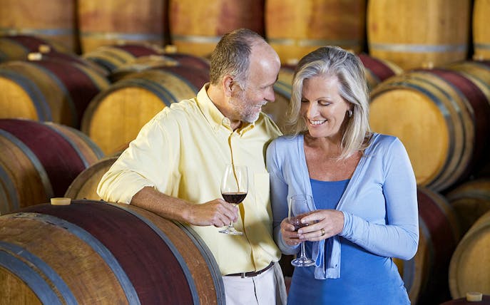 Couple enjoying wine tasting in a cellar on a tour from Lisbon to Èvora.