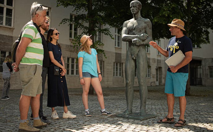 Tour guide explaining a statue to a group during a Third Reich & World War II tour in Berlin.