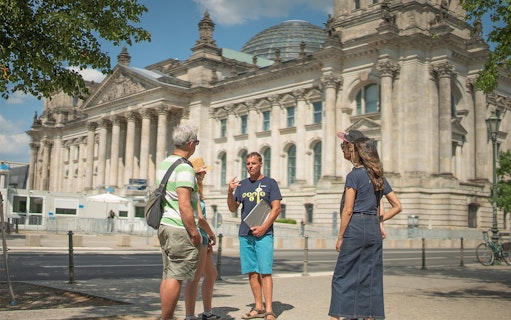 Tour group with guide outside the Reichstag building in Berlin.