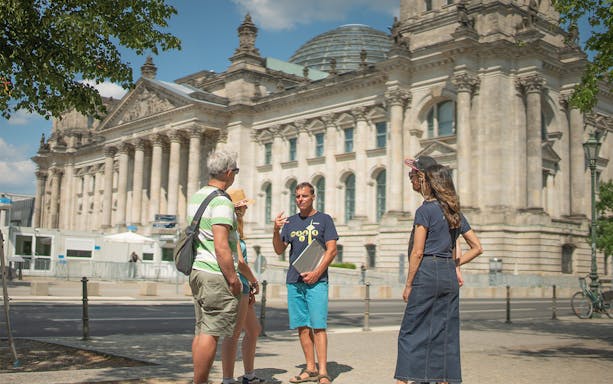 Tour group with guide outside the Reichstag building in Berlin.