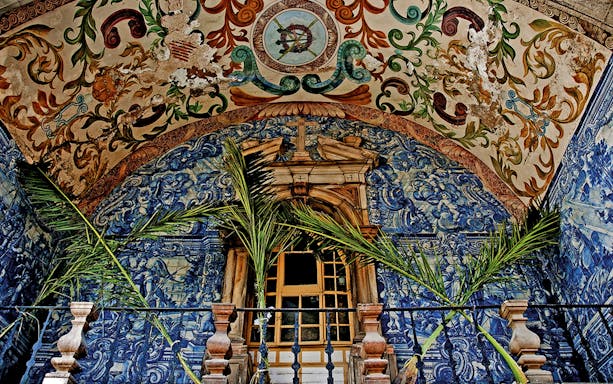 Ornate azulejo tiles and painted ceiling in Óbidos, Portugal.