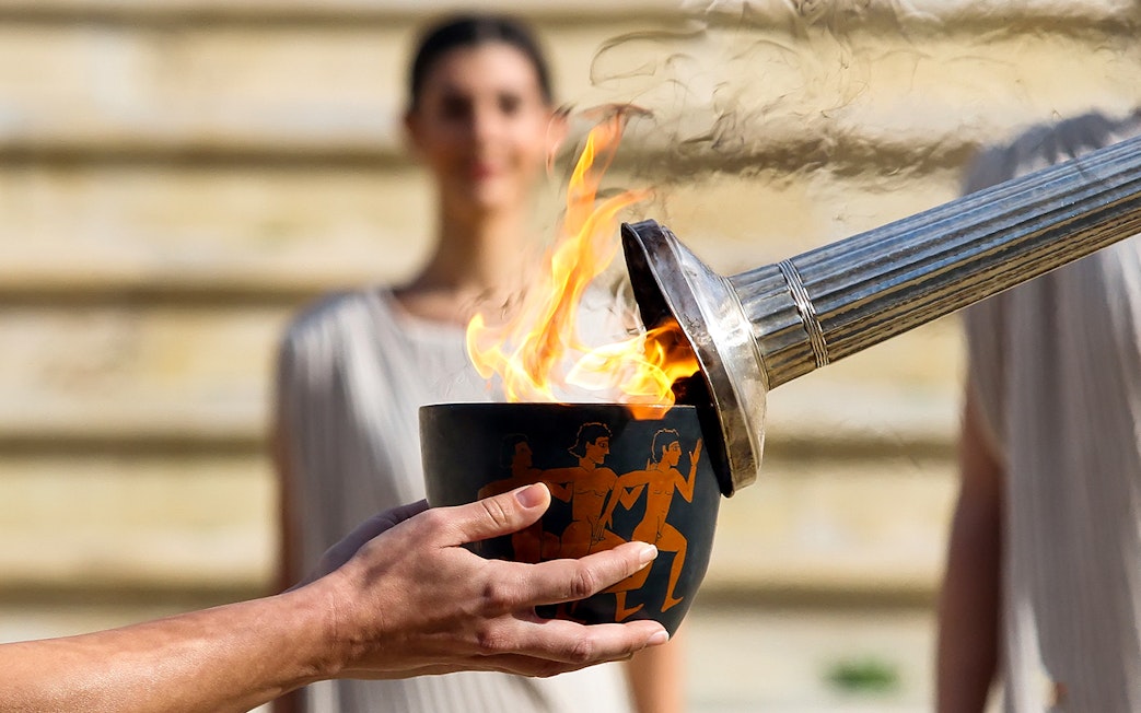 Flame being lit in a ceremonial bowl at Ancient Olympia, Greece.