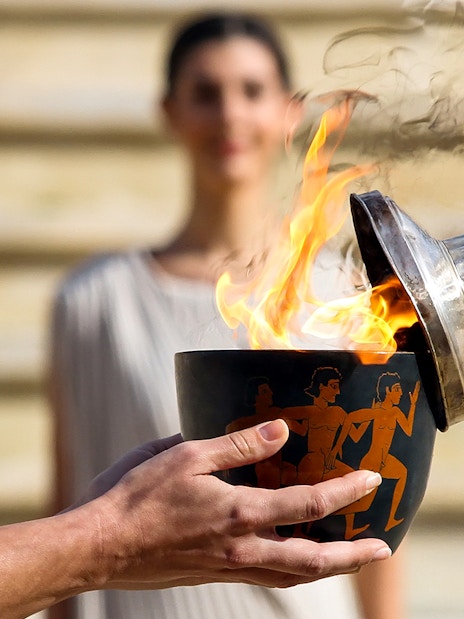 Flame being lit in a ceremonial bowl at Ancient Olympia, Greece.