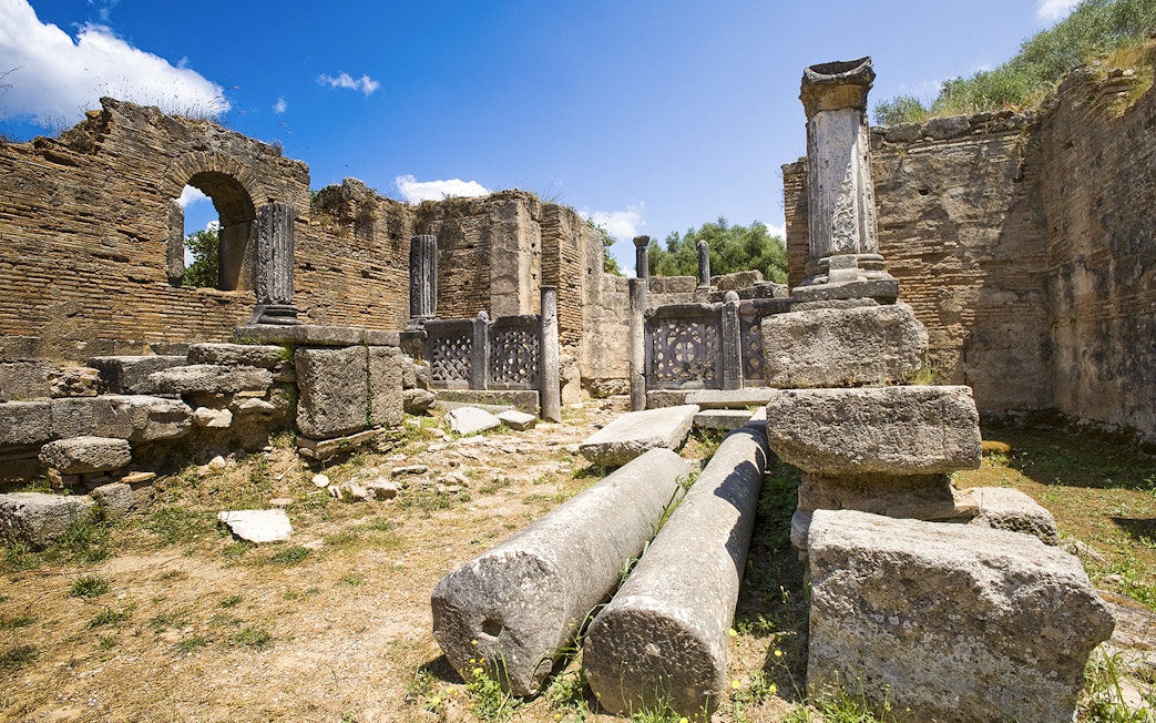 Ancient ruins with columns at Olympia Archaeological Site, Greece.