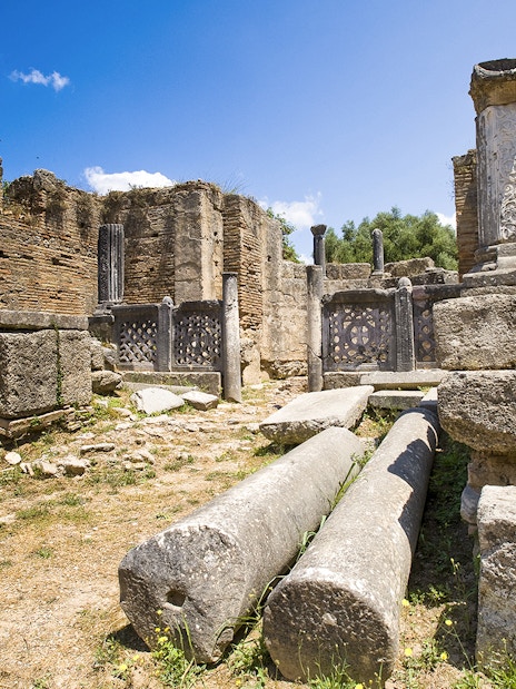 Ancient ruins with columns at Olympia Archaeological Site, Greece.