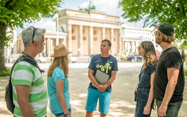 Tour group with guide near Brandenburg Gate, Berlin.