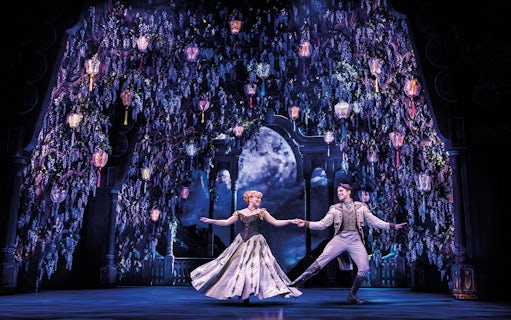Characters dancing under lanterns in a scene from Frozen The Musical.