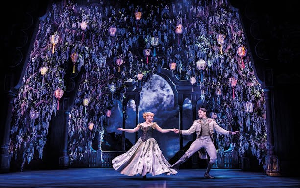 Characters dancing under lanterns in a scene from Frozen The Musical.