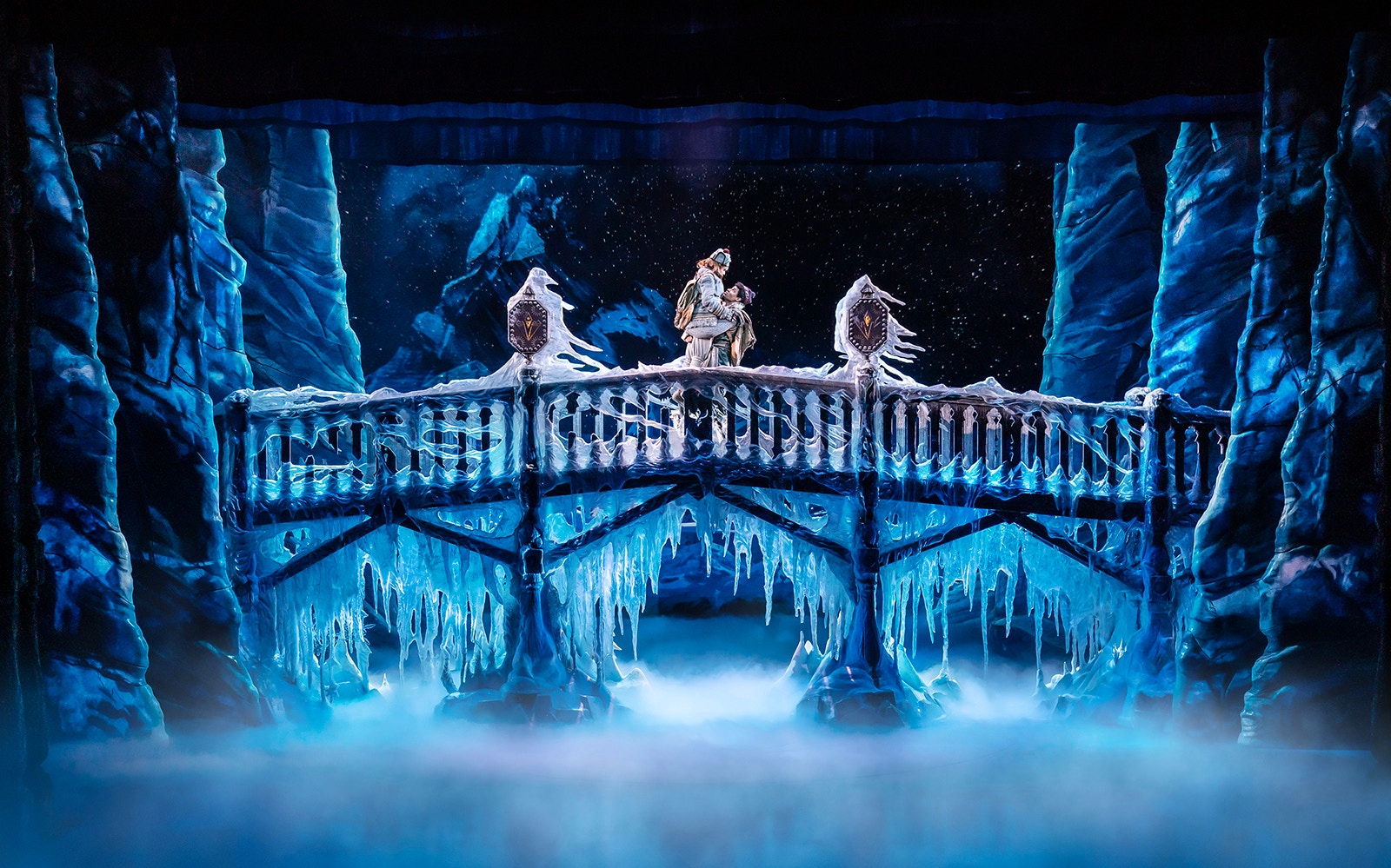Frozen The Musical stage scene with characters on an icy bridge.