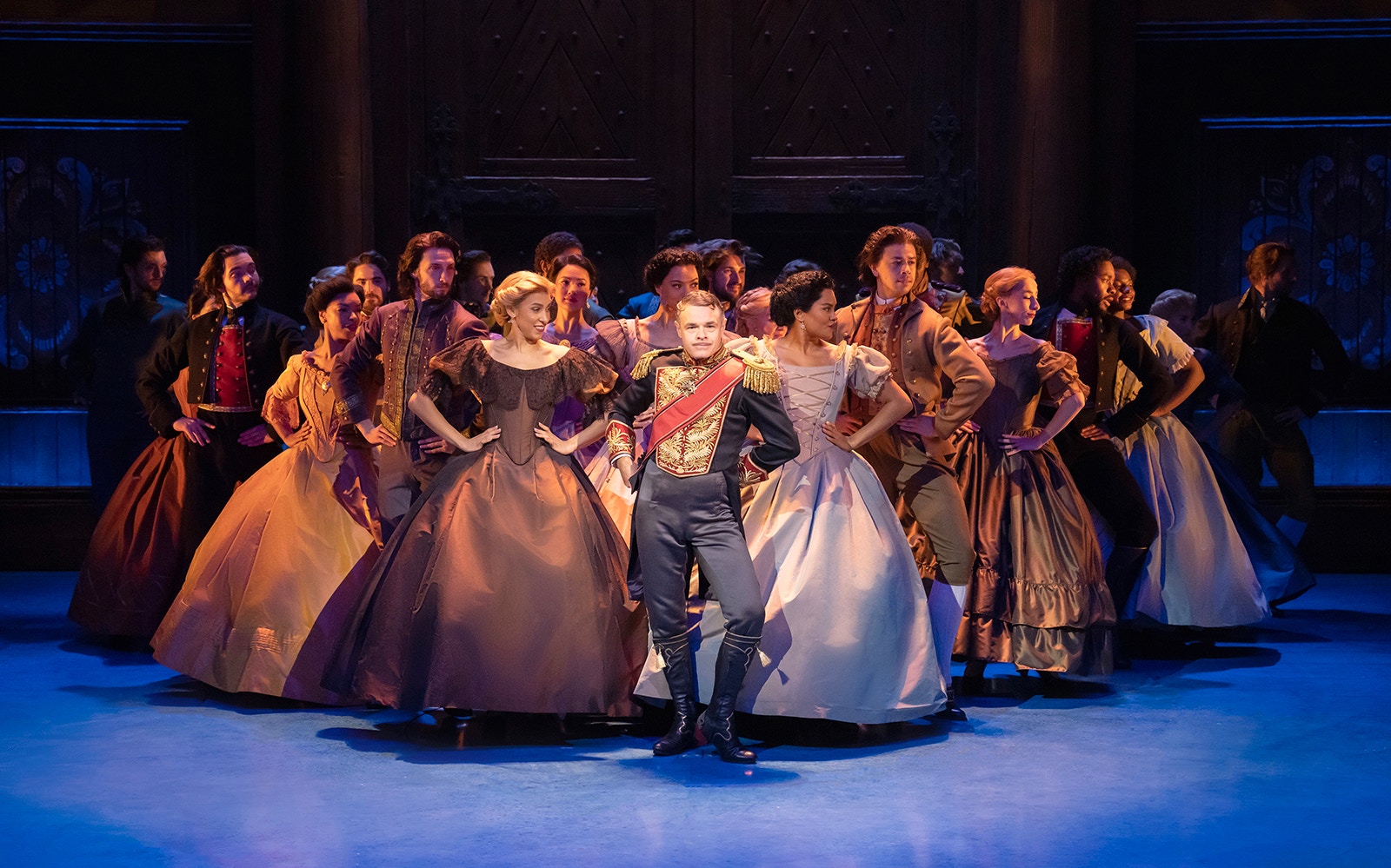 Cast performing a dance scene in Frozen The Musical on stage.
