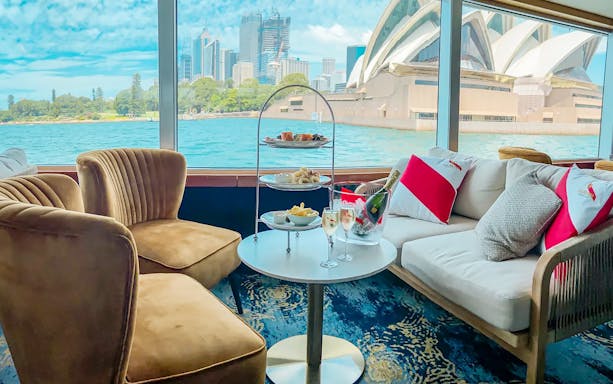 Luxurious seating with champagne and snacks overlooking Sydney Opera House at Mumm Champagne Harbour Bar.