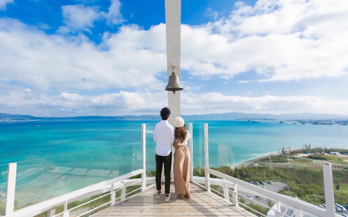 Visitors enjoying the view from Kouri Ocean Tower, overlooking the ocean in Okinawa, Japan.