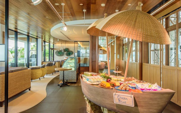 Buffet display at Kouri Ocean Tower restaurant with assorted pastries and fruits.