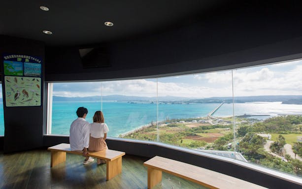 Couple enjoying ocean view from Kouri Ocean Tower, Okinawa.