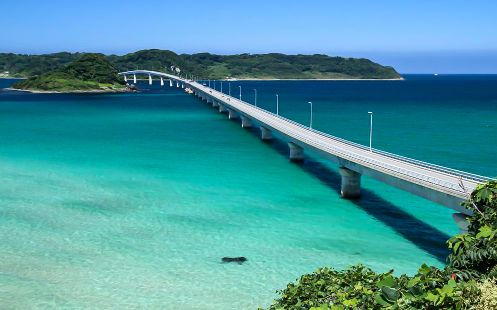 Bridge over turquoise waters in Okinawa, Japan, part of the Hip Hop Bus Tour.