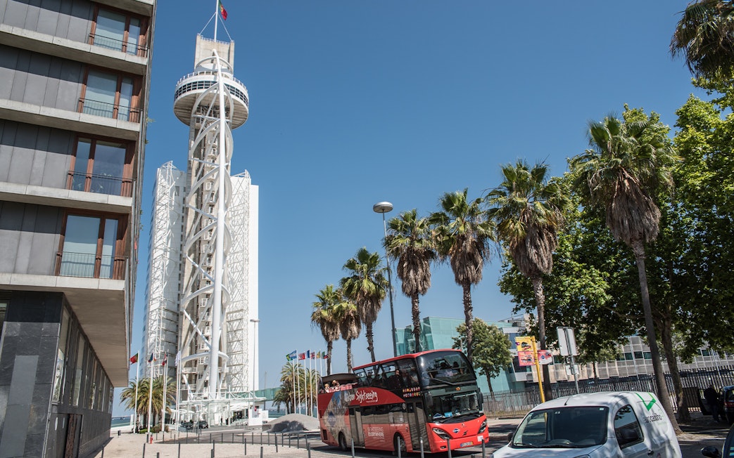 Hop-on-hop-off tour bus near Vasco da Gama Tower in Lisbon.