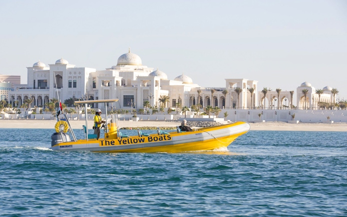 Yellow speedboat touring near Qasr Al Watan, Abu Dhabi.