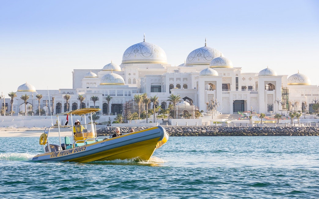 Yellow speedboat touring near Qasr Al Watan, Abu Dhabi.