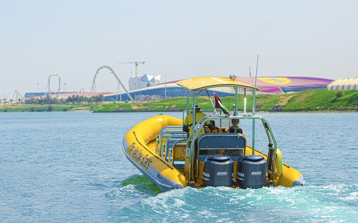 Speedboat on Yas Island tour with theme park in background.