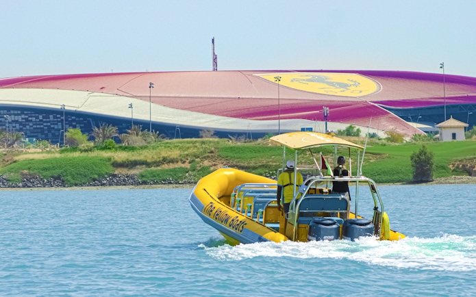 Speedboat on Yas Island tour passing Ferrari World Abu Dhabi.