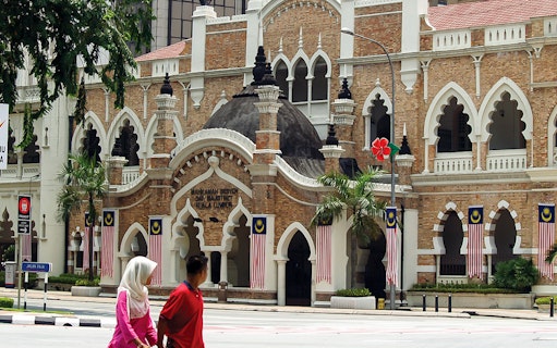 Sultan Abdul Samad Building in Kuala Lumpur with Malaysian flags.