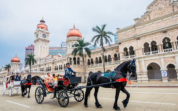Horse-drawn carriage in front of Sultan Abdul Samad Building, Kuala Lumpur.