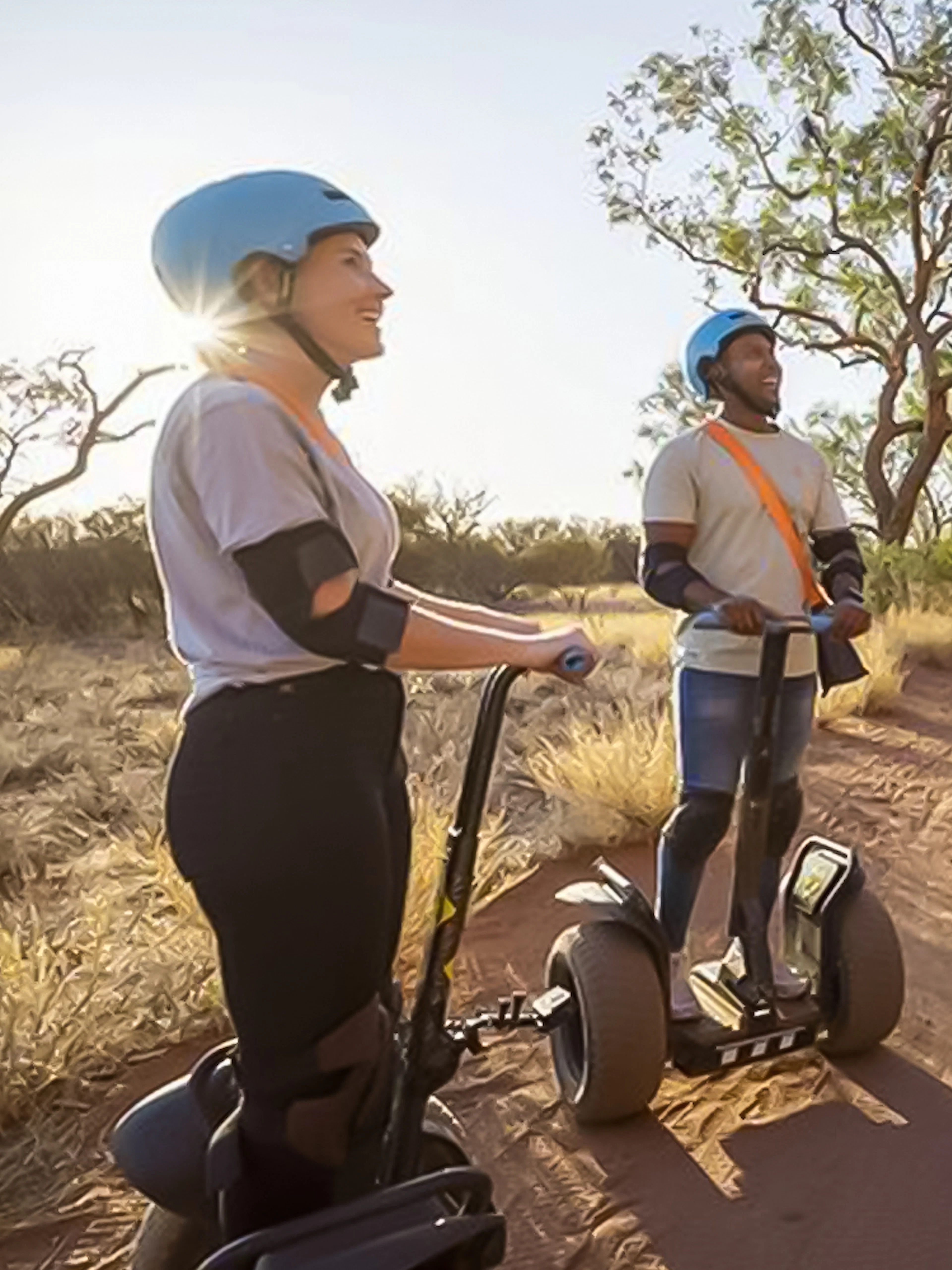 Group on Segways exploring Uluru's desert landscape.
