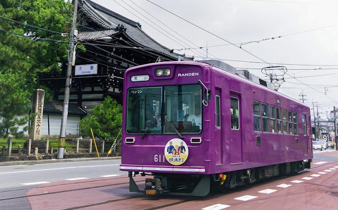 Purple Randen train passing by Toei Kyoto Studio Park in Uzumasa, Kyoto.